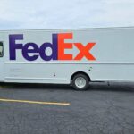 fedex truck driver side with blue car